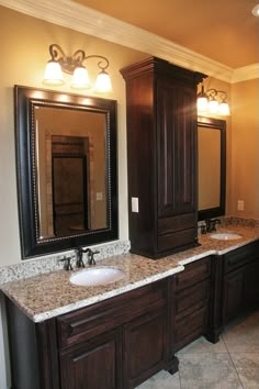 a bathroom with double sinks and two mirrors