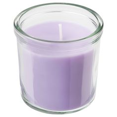 a purple candle in a clear glass container