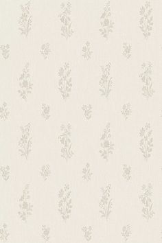 a white wallpaper with small flowers on it