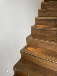 wooden steps leading up to a white wall