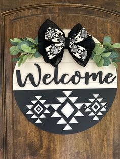 a welcome sign with a bow on it