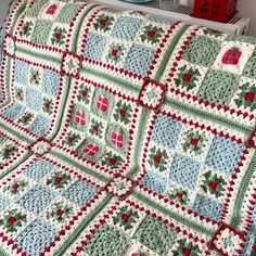 a crocheted blanket is sitting on a couch