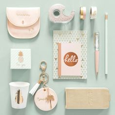 various items are arranged on a table including a card, pen, cup and keychain