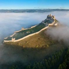 an aerial view of a castle in the clouds