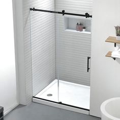 a white bathroom with a shower and sink