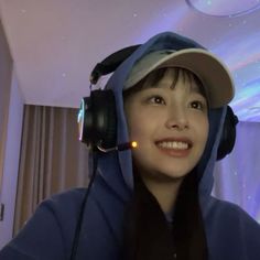 a woman wearing headphones and a blue hoodie