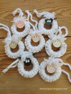 sheep made out of yarn sitting on top of a wooden table