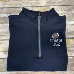 a black hoodie with the coach joe embroidered on it's chest and zipper