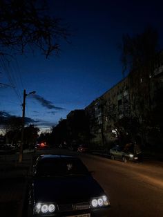 a car is parked on the side of the road at night