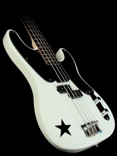 an electric bass guitar with black and white strings