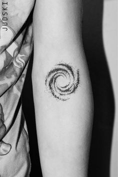 a couple of people with tattoos on their arms and legs, one has a small spiral tattoo