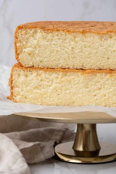 two slices of white cake sitting on top of a cake plate next to each other