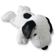 a white and black stuffed dog laying on its side