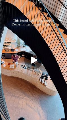 an aerial view of a spiral staircase in a building with text overlaying the image