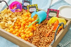 a wooden box filled with cereal and other snacks