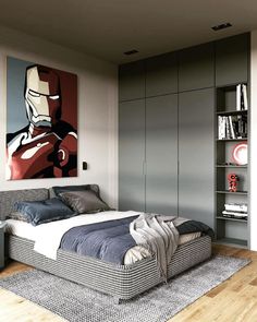 a bedroom with a bed, bookshelf and pictures on the wall