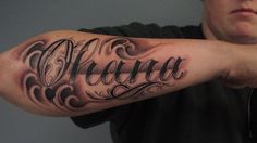 a man with a tattoo on his arm that says alotra in cursive writing