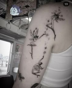 a woman's arm with tattoos on it and the image of tinkerbells