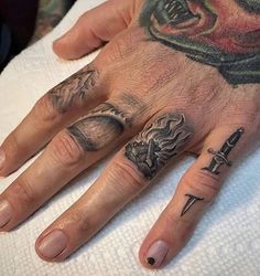 a person with tattoos on their hands and fingers