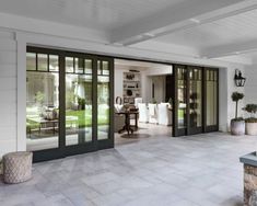 an open patio area with sliding glass doors and potted plants