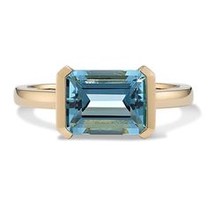 Simply stunning  this dreamy 14-karat yellow gold ring shines the spotlight on a single  natural aquamarine gemstone. It features an emerald cut positioned in a unique east-west (horizontal) orientation in a bezel setting. East West Sapphire Engagement Ring, Unique Gemstone Ring, Modern 14k Gold Emerald Cut Topaz Ring, Modern Blue Baguette Cut Emerald Ring, Modern Yellow Gold Topaz Ring With Rectangular Shape, 14k Gold Emerald Cut Topaz Ring, Timeless Emerald Cut Yellow Gold Topaz Ring, Timeless Emerald-cut Topaz Ring In Yellow Gold, Modern Rectangular Blue Topaz Ring