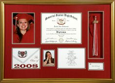 a framed diploma and other items in a red frame with gold trim, including a tassel