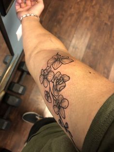 a person with a flower tattoo on their arm