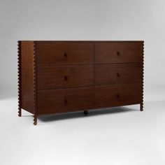 a large wooden dresser sitting on top of a white floor