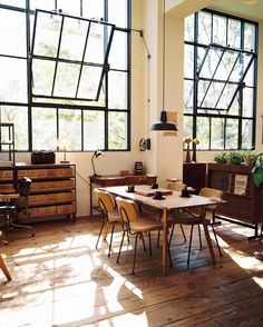 a room with wooden floors and large windows