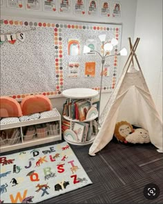 a child's room with a teepee tent and bookshelves