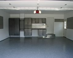 an empty garage with lots of storage cabinets