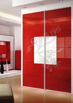 a red and white room with an artistic design on the glass door to the closet