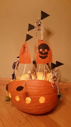 a pumpkin decorated like a pirate ship with halloween decorations