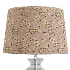 a lamp with a pink and white flower pattern on the lampshade is shown