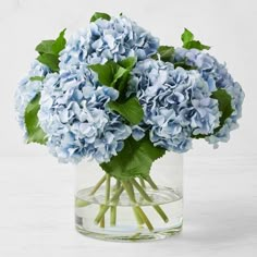 a vase filled with blue flowers on top of a table