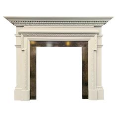 a white fireplace with an ornate design on the top and bottom, against a white background