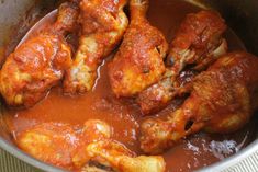 some chicken wings are being cooked in a sauce