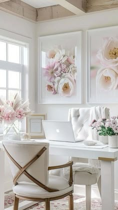 a white desk topped with a laptop computer sitting next to a flower filled window sill