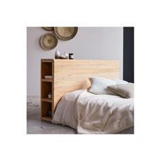 a bed with a wooden headboard and night stand