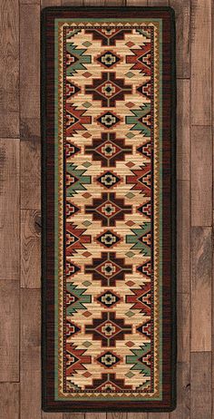 an area rug with wood flooring and wooden walls in the background, featuring a southwestern style design