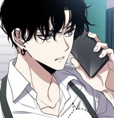 a man holding a cell phone to his ear and looking at the screen while wearing a white shirt