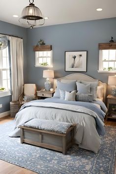 a bedroom with blue walls and white bedding in the center, along with two lamps on either side of the bed