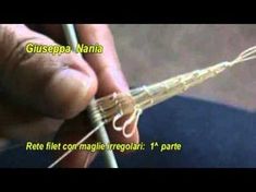 a person is holding a needle in their right hand and writing on it with the words gussepa nanja