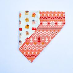 two bandannas with christmas designs on them, one red and the other white