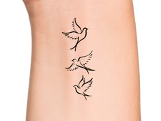 a woman's arm with two birds tattoo on the left side of her body