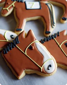 decorated cookies in the shape of horses on a table