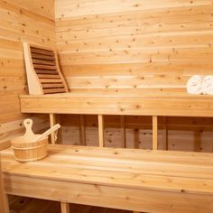 a sauna with wooden benches and towels on it