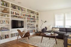 a living room filled with furniture and bookshelves