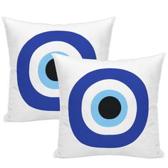 two blue and white pillows with black circles on the front, one has an eyeball design