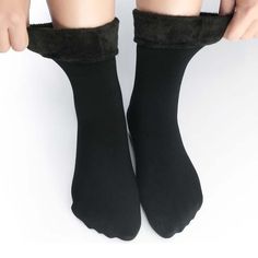 Keep even the coldest feet warm this winter, with our fully-lined, Cozy Faux Fur Socks. Whether you're curling up on the couch, wrapped in your favorite plush blankets, and sipping on a cup of cocoa, or you're heading out the door for a night of shopping, a bite to eat, or the latest blockbuster movie, these stylish and Cozy Faux Fur Socks are guaranteed to keep your toes warm and comfy this winter! These comfortable socks are the absolute coziest socks ever and they boast all of the very best f Cozy Black Socks For Cold Weather, Snug Solid Winter Socks, Cozy Black Socks For Stocking Stuffers, Warm Black Socks For Stocking Stuffers, Super Soft Solid Winter Socks, Snug Winter Socks, Warm Black Winter Socks, Thick Black Winter Socks, Super Soft Comfortable Winter Socks